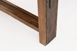 Jacques Adnet's coffee table/bench detailed view of leather and wood of leg